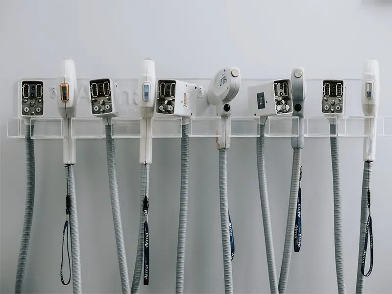 A row of different types of wires hanging on the wall.